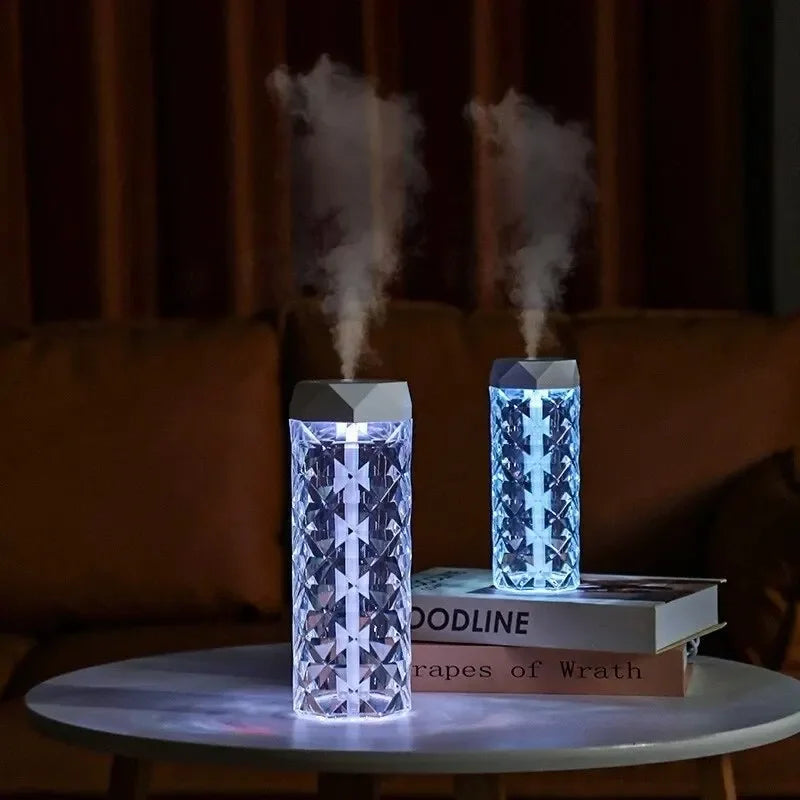 Crystal pattern LED humidifiers emitting mist on a table in a modern living room
