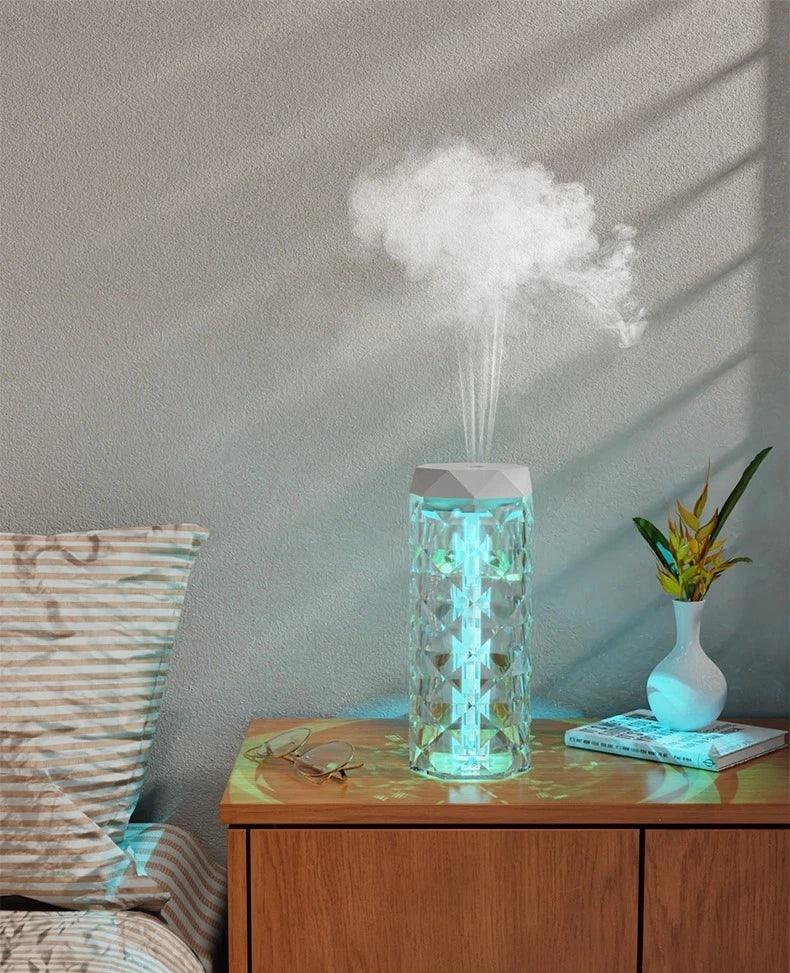 Modern crystal design humidifier with LED light on a bedroom nightstand, emitting cool mist